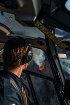 A person looks down at an erupting volcano on the Reykjanes peninsula from the safety of a helicopter.