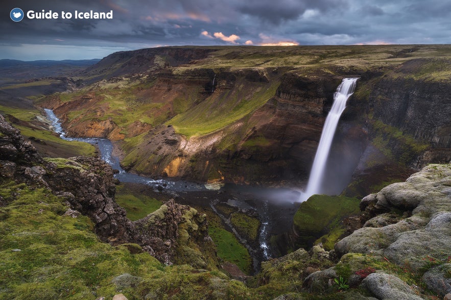 Haifoss waterfall plunging into a canyon in South Iceland, surrounded by mossy cliffs and dramatic volcanic terrain under a moody sky